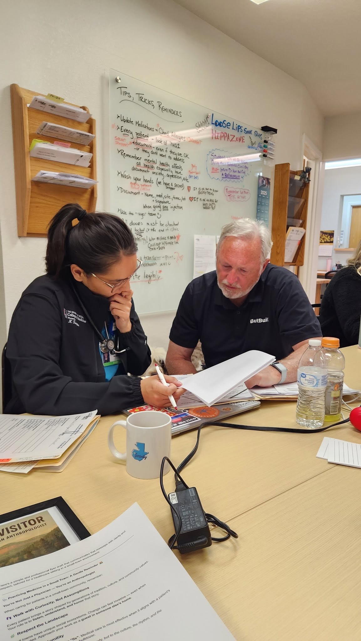 A medical student reviewing patient information with a supervising clinician